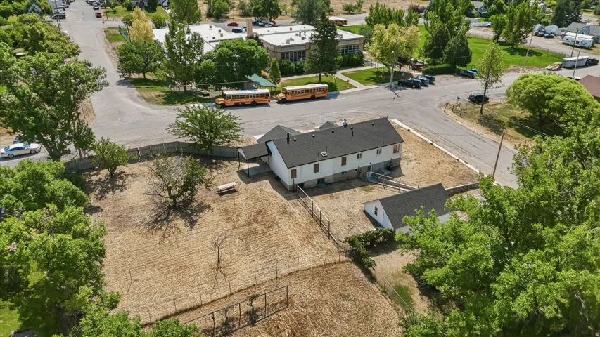 Aerial perspective showcasing the property with a main residence and a detached auxiliary building