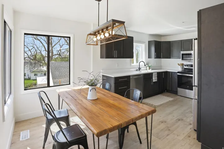 Kitchen featuring dark cabinetry, stainless steel appliances, and light countertops