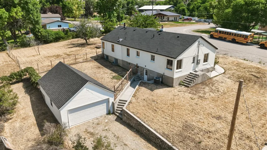 White exterior residence with a dark shingle roof