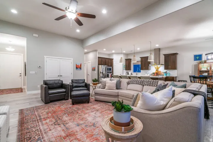 Living room featuring ceiling fan, light wood finished floors, and recessed lighting