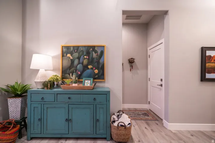 Corridor featuring baseboards and light wood-style floors
