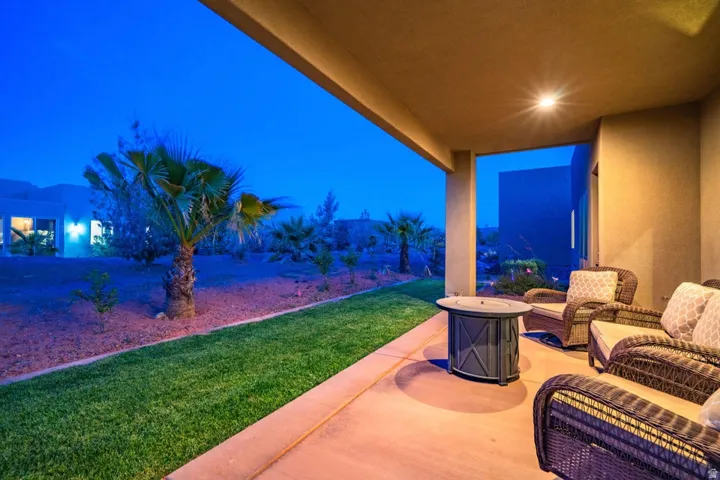 Patio at twilight with a patio, a lawn, and an outdoor hangout area