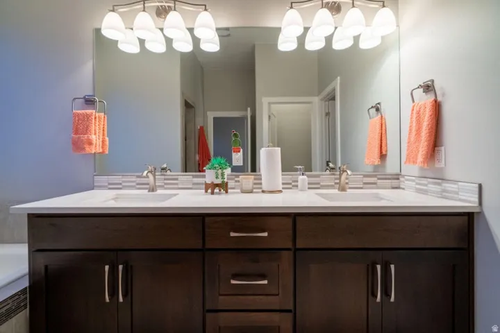 Full bathroom with double vanity and a bath