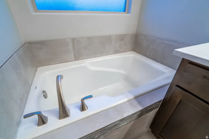Full bathroom featuring a bath and vanity
