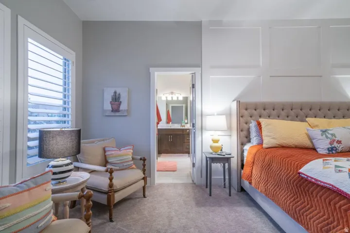 Carpeted bedroom featuring ensuite bathroom