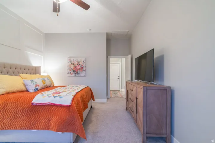 Bedroom with light carpet and ceiling fan