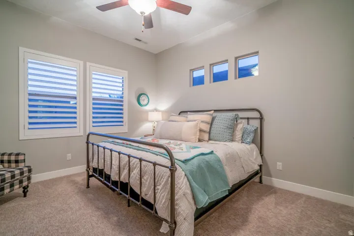 Bedroom with a ceiling fan and carpet flooring