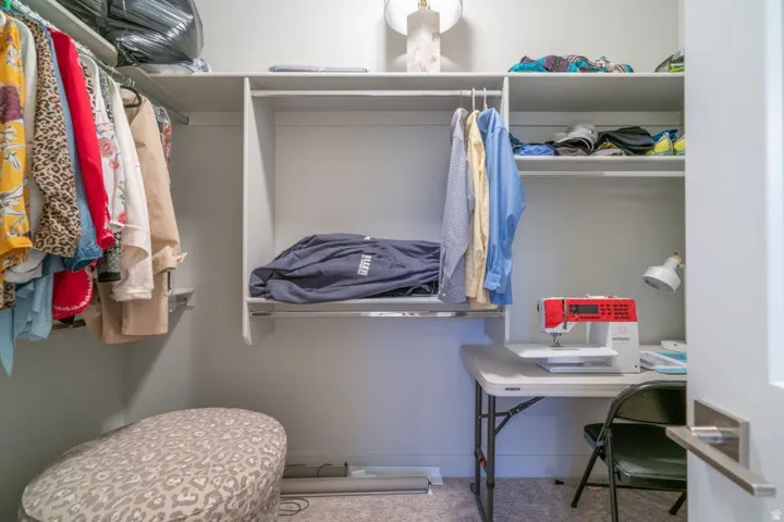 Walk in closet featuring light carpet