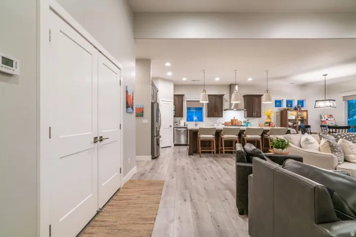 Living room with light wood finished floors and recessed lighting
