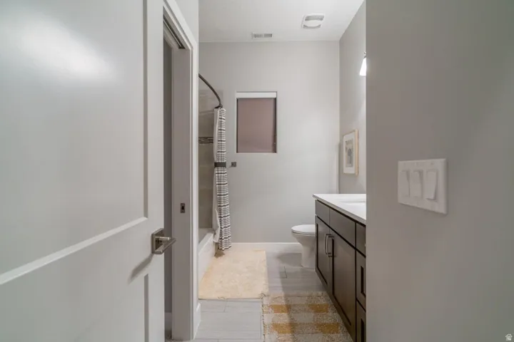 Full bathroom with vanity and shower / tub combo with curtain