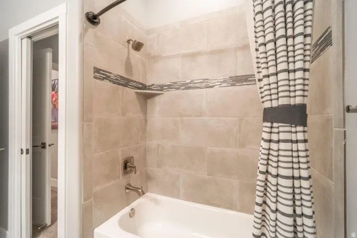 Full bath featuring shower / bath combo with shower curtain