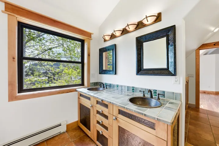 Dual vanity with integrated bronze vessel sinks and bronze-finish faucets