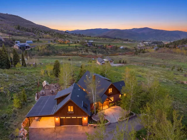 Mountain-style residence featuring a multi-level design, attached garage, and a covered carport