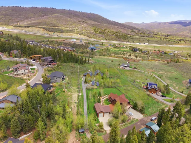 Mountainous landscape with scattered residences and a visible roadway