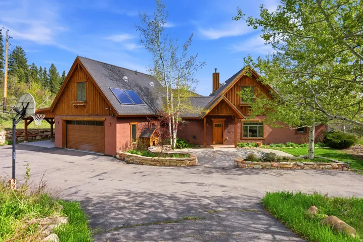 Two-story home with a wood-finish facade and dark gray roof