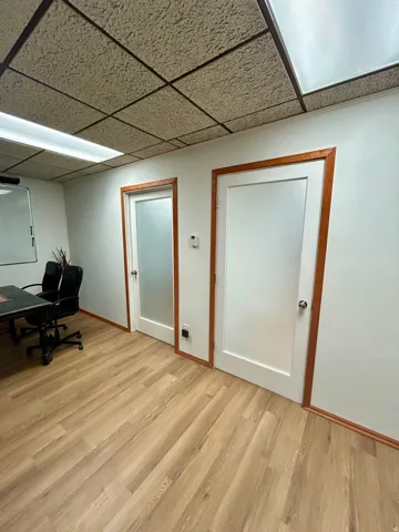 Light wood-finish flooring extending throughout the space
