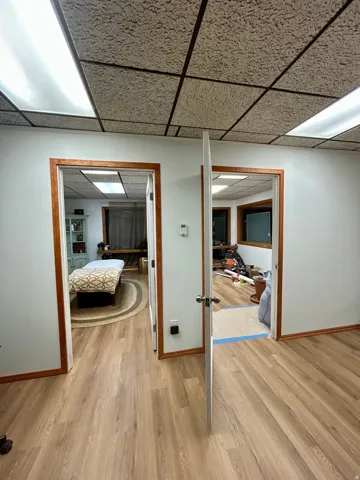Light wood-finish flooring extending through two doorways