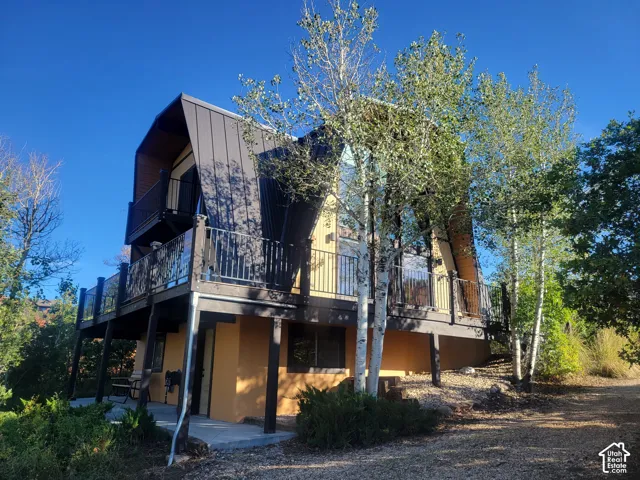A-frame exterior with multi-level balconies, dark metal roofing, and multiple windows