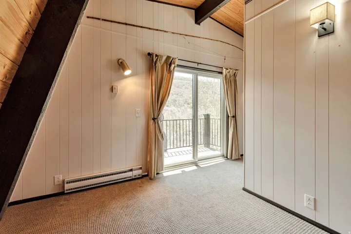Sliding glass doors opening to an outdoor balcony with metal railing
