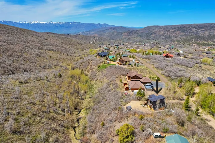 Mountain landscape with a residential property situated on a hillside