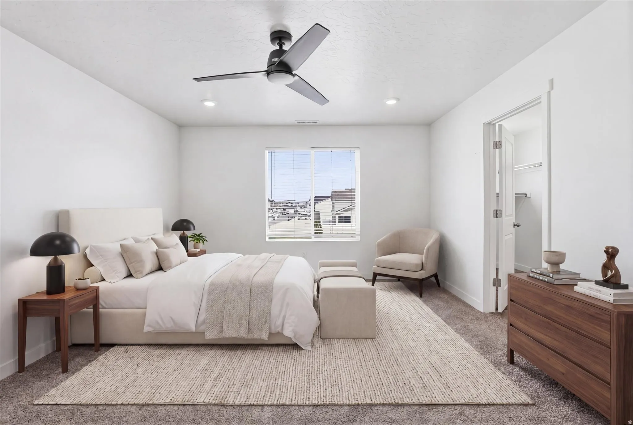 Spacious bedroom featuring a large window, contemporary ceiling fan, recessed lighting, and soft carpet flooring