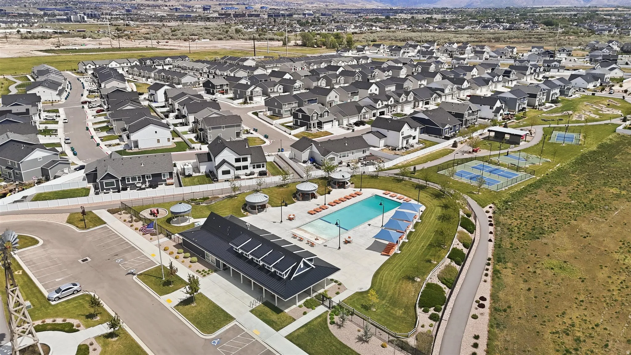 Community amenities featuring a swimming pool, clubhouse, tennis courts, and walking paths