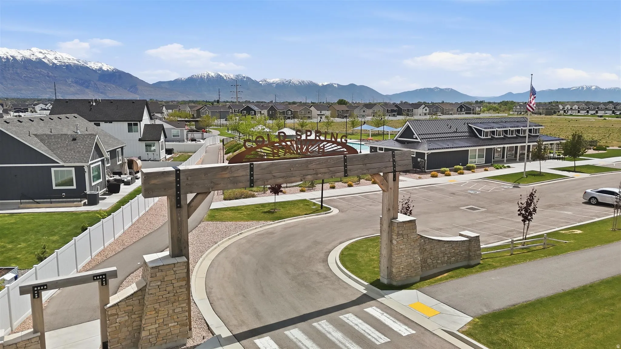 Community entrance featuring a stone and wood-beam archway