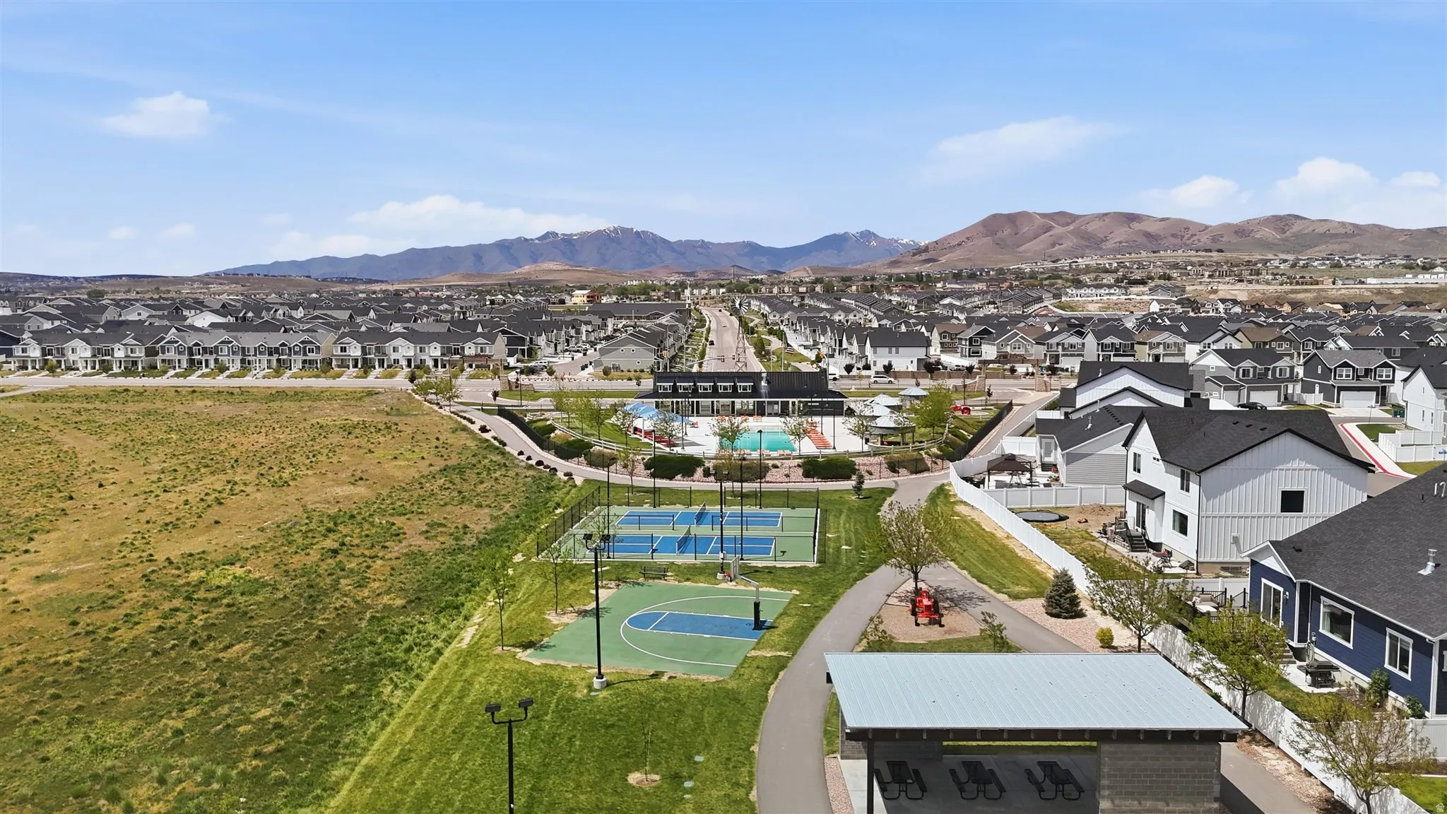 Community amenities featuring a swimming pool, multiple tennis courts, a basketball court, and a covered pavilion