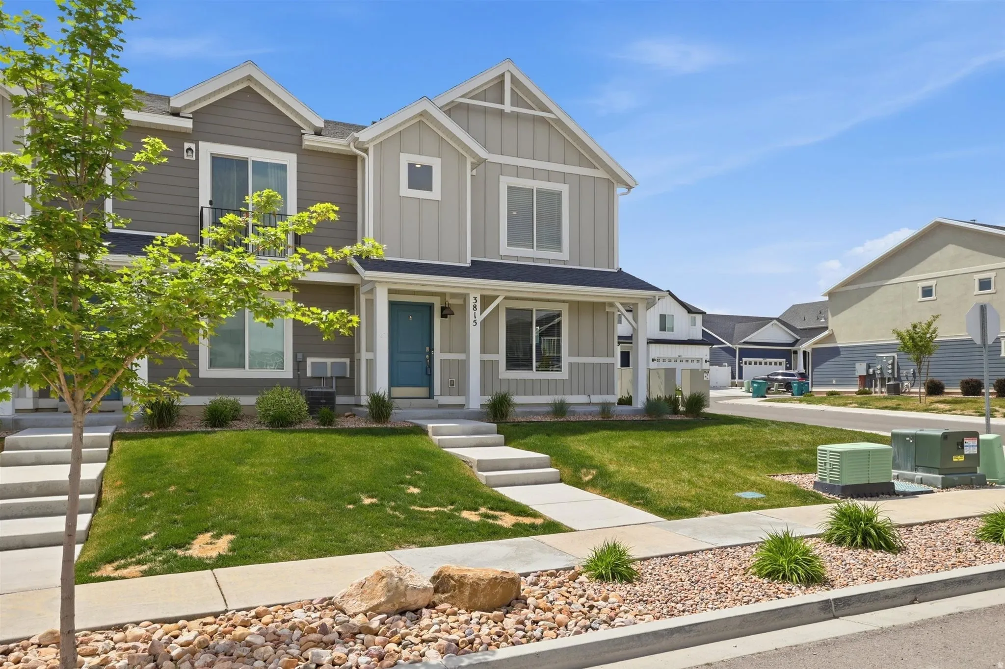 Contemporary townhome exterior featuring light siding with vertical and horizontal accents