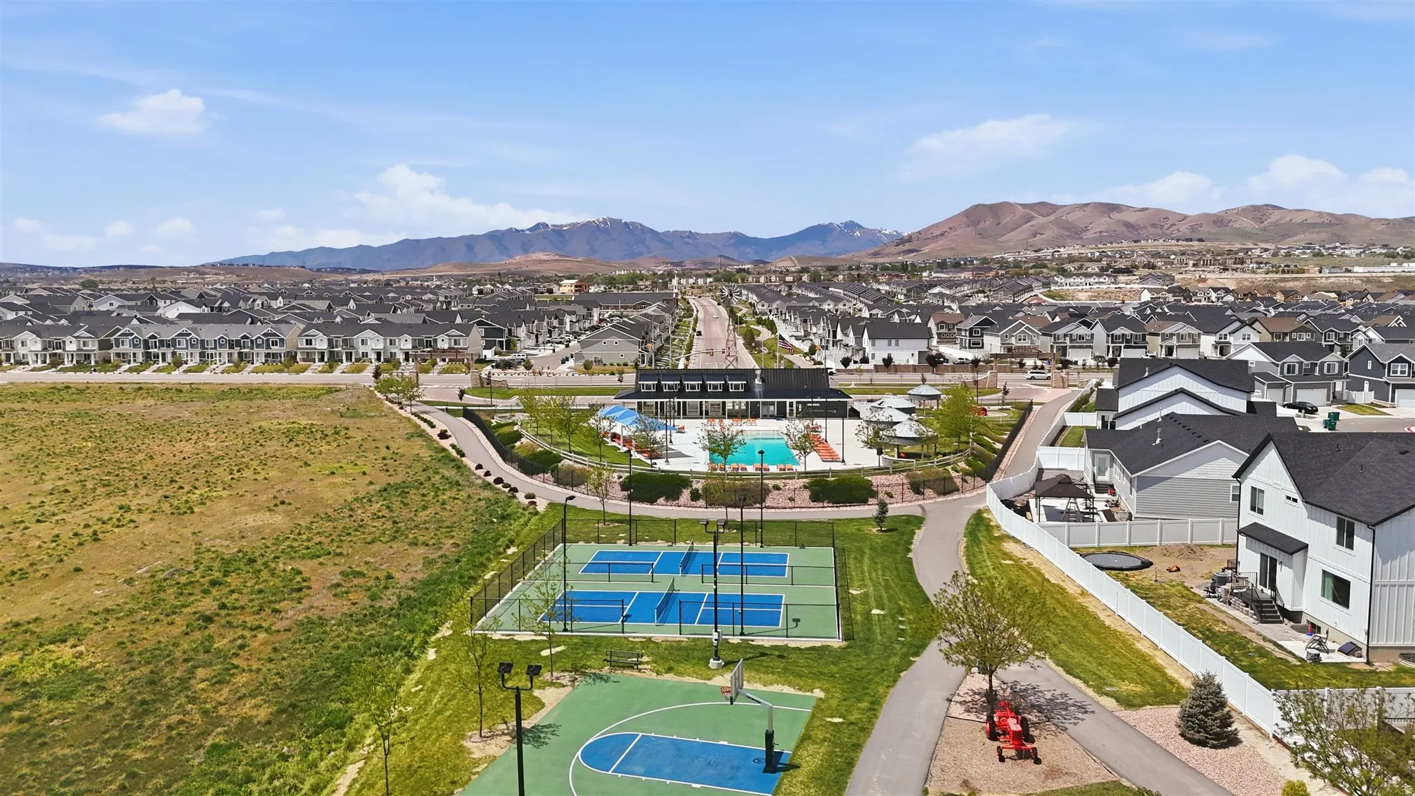 Community amenities featuring pickleball courts, a basketball court, and a swimming pool area