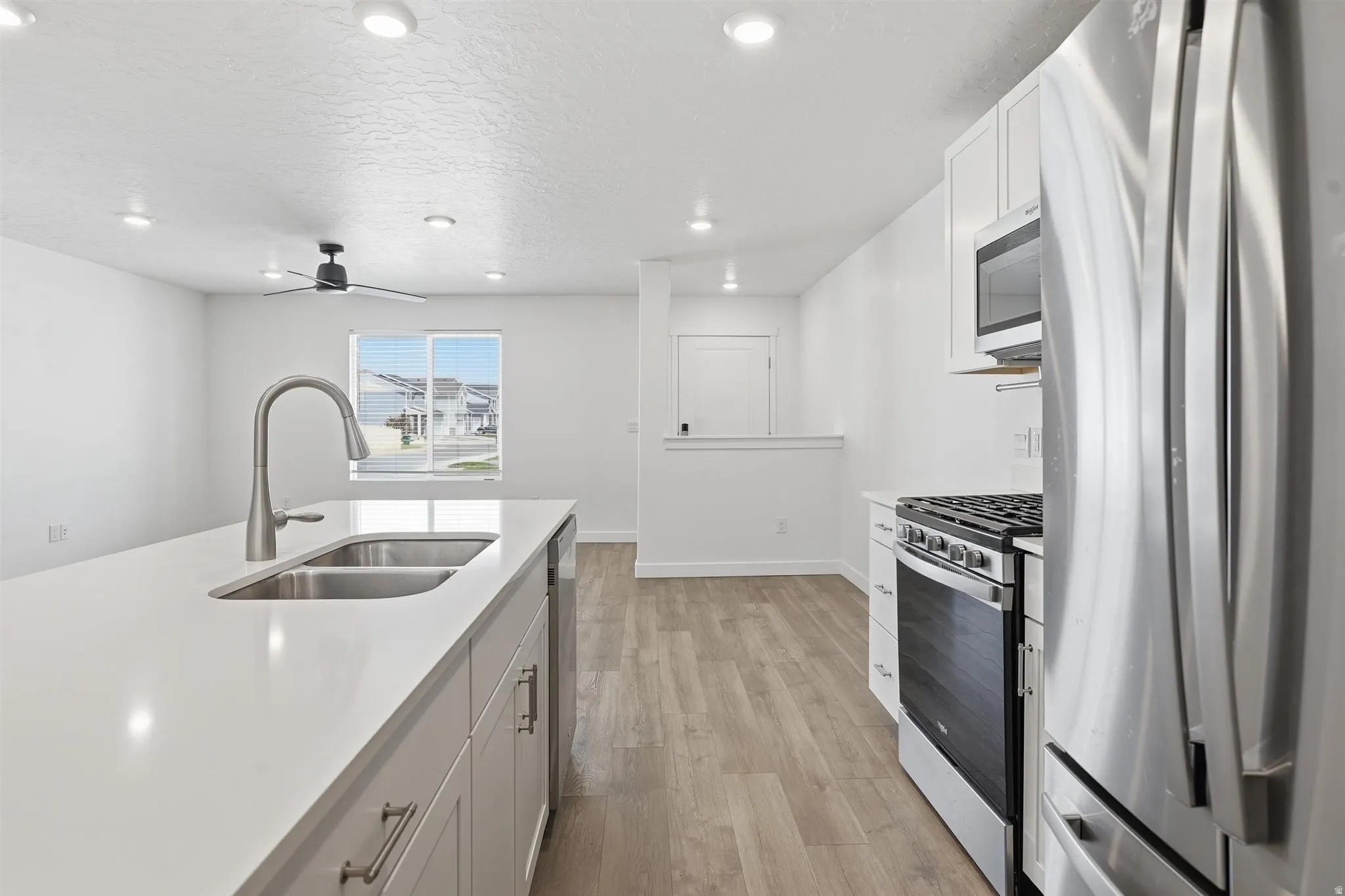 Kitchen island with a double basin stainless steel sink and gooseneck faucet
