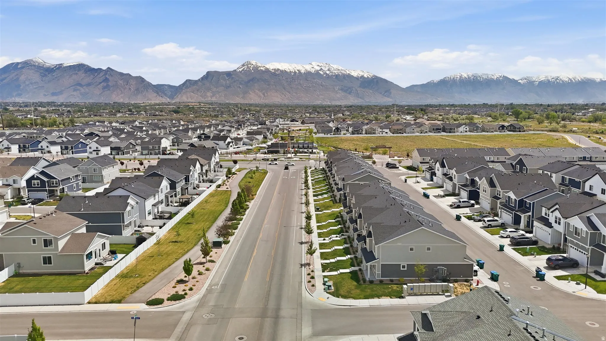 Expansive community featuring diverse residential architecture with mountain backdrop