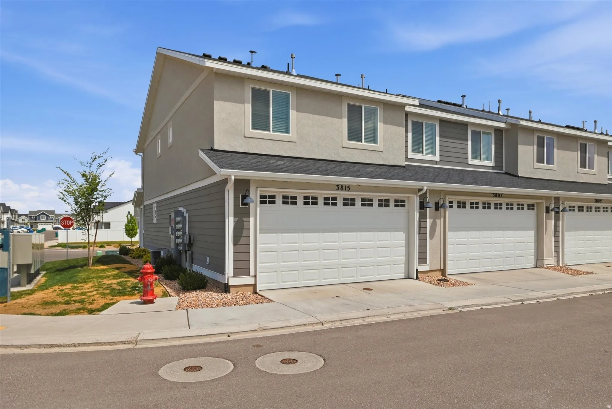 Townhome exterior featuring varied siding materials including horizontal panels and stucco