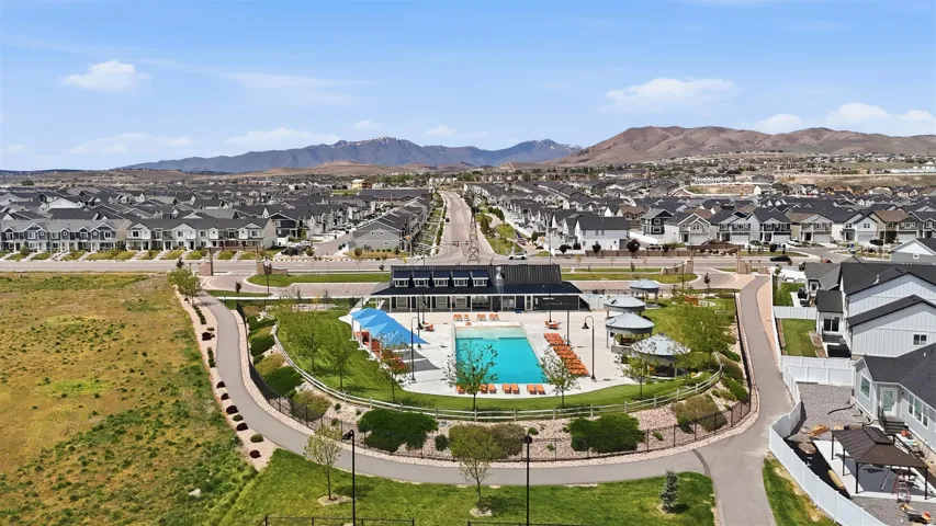 Community recreation center featuring an outdoor swimming pool, lounge seating, and shaded cabanas