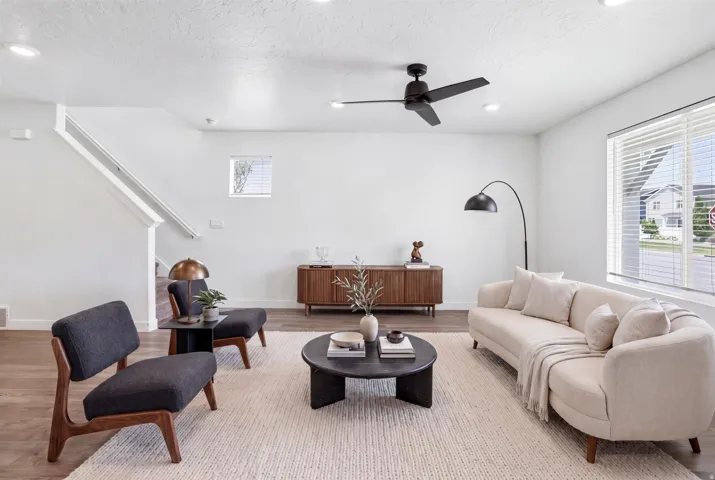 Open-concept living space with wood-finish flooring and a neutral color palette