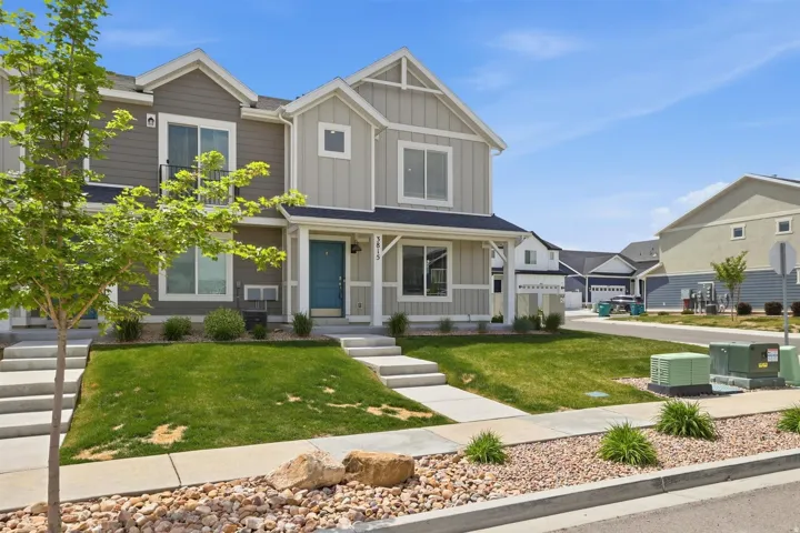 Contemporary townhome exterior featuring light siding with vertical and horizontal accents