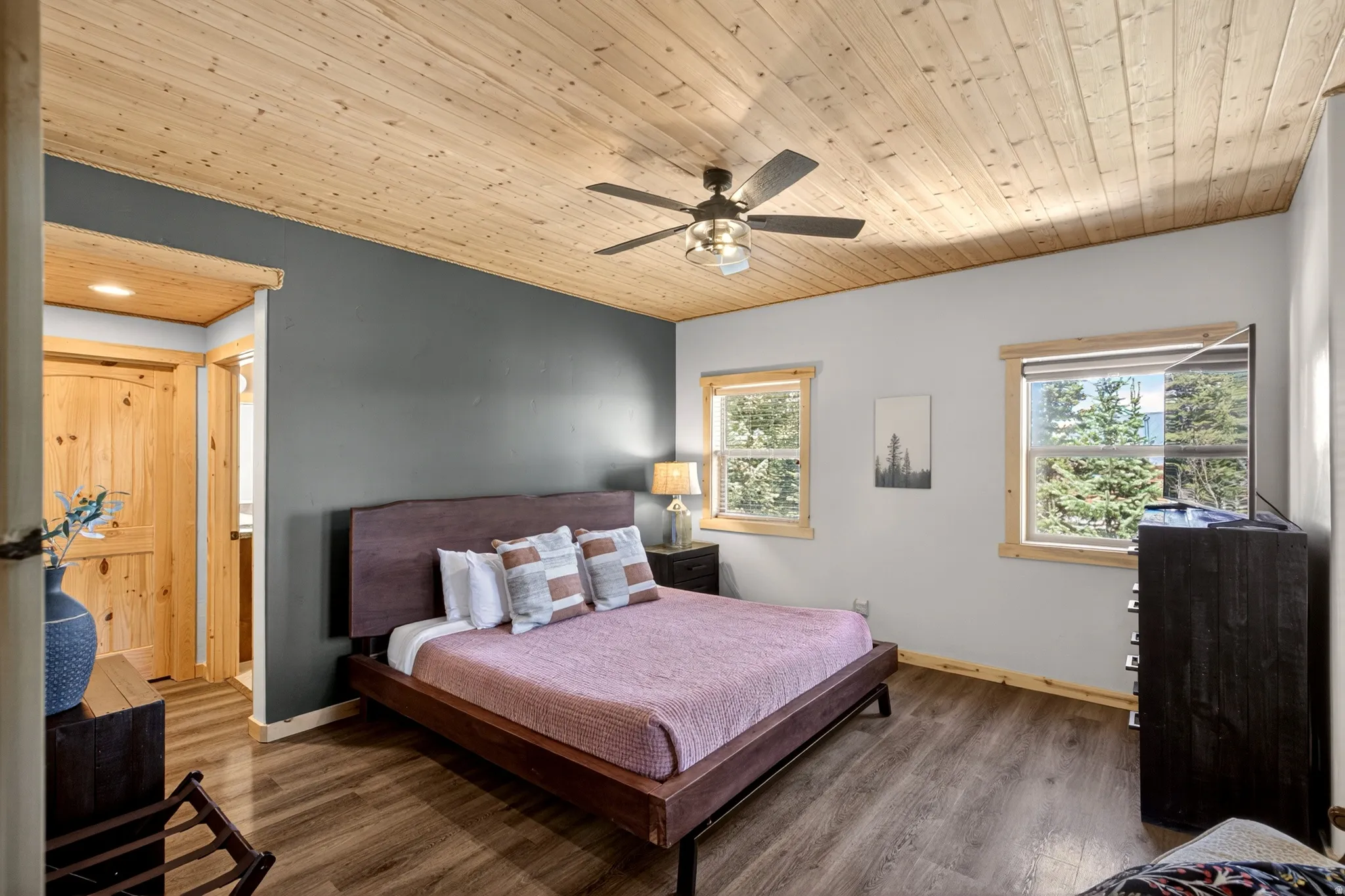 Wood-finish flooring and a natural wood plank ceiling create a warm ambiance