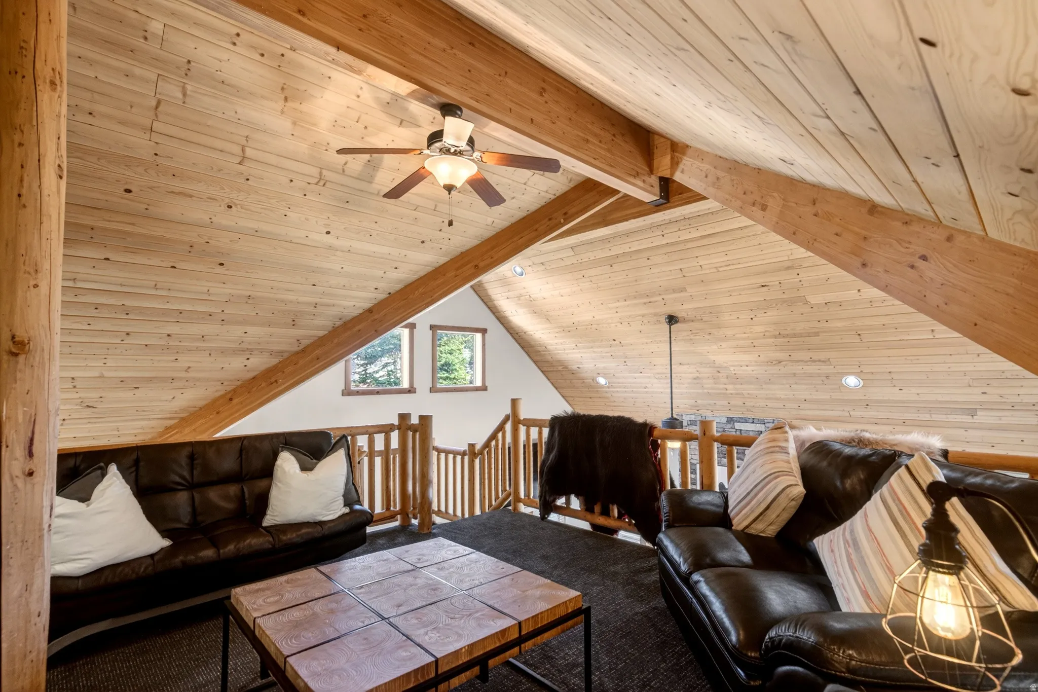 Vaulted wood-paneled ceilings featuring exposed wood beams and recessed lighting