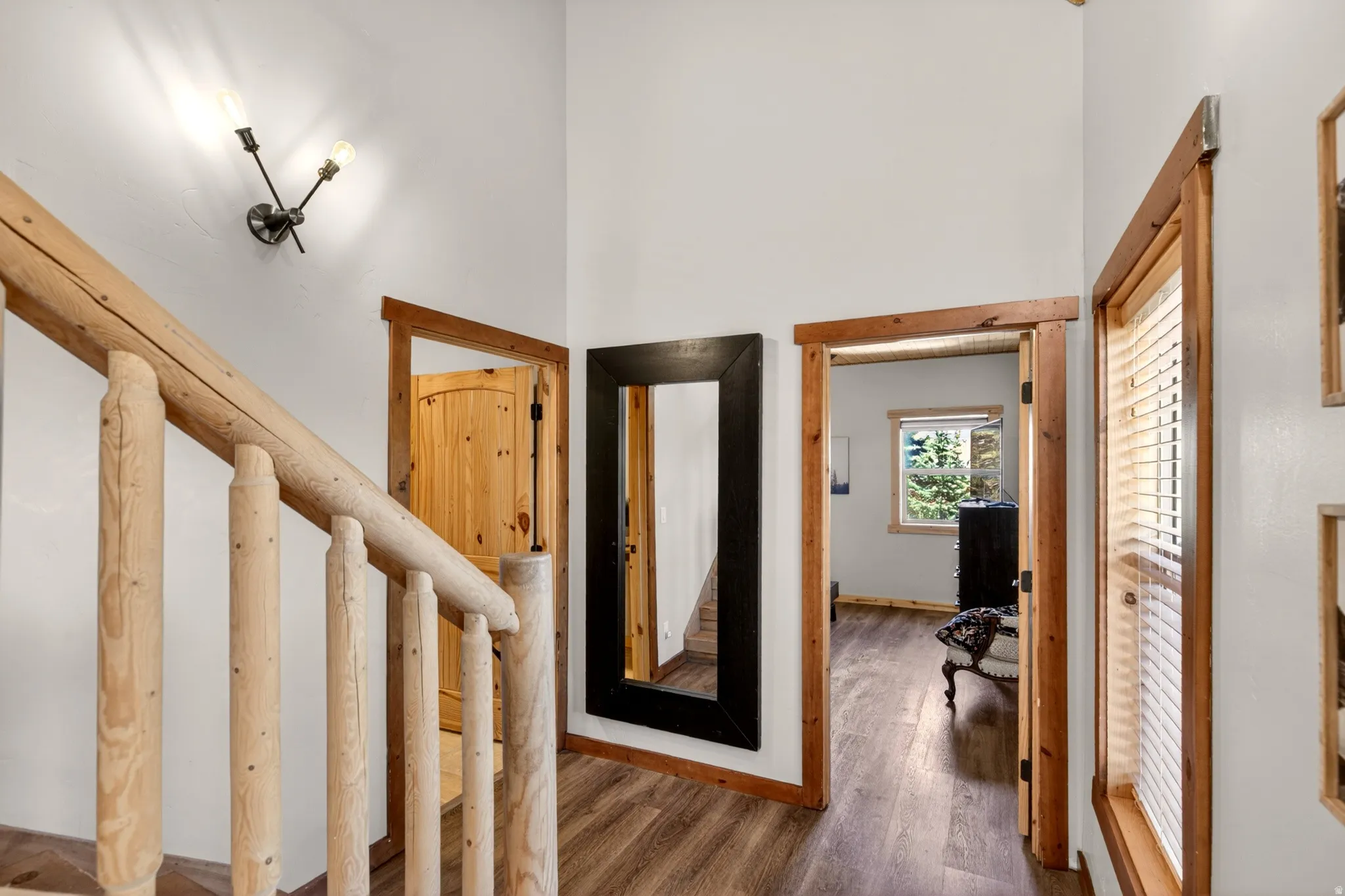 Rustic timber railing and balusters complement the wood-finish flooring
