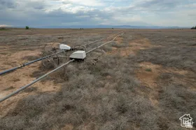 Expansive agricultural land featuring a wheel-line irrigation system