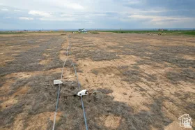 Expansive undeveloped land with visible utility infrastructure