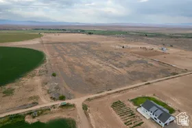 Expansive rural property featuring a vast landscape of agricultural fields and open land