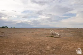 Expansive open land with a flat topography, featuring visible irrigation piping