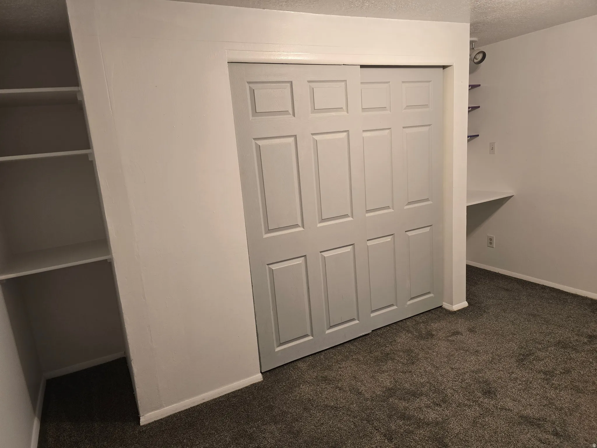 Gray sliding bifold closet doors with a paneled design