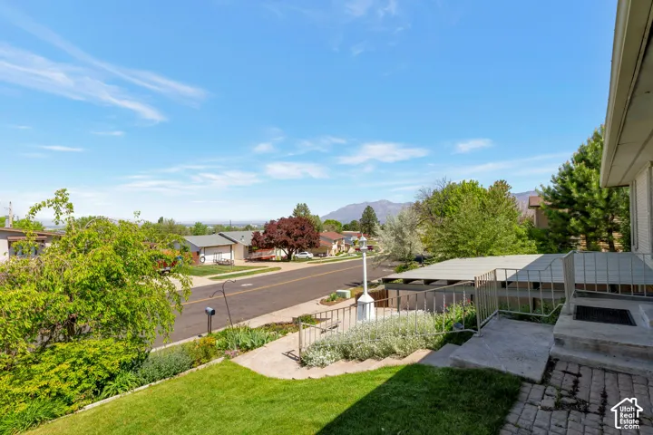 Front entrance with paver landing, metal railing, and covered carport, fantastic views