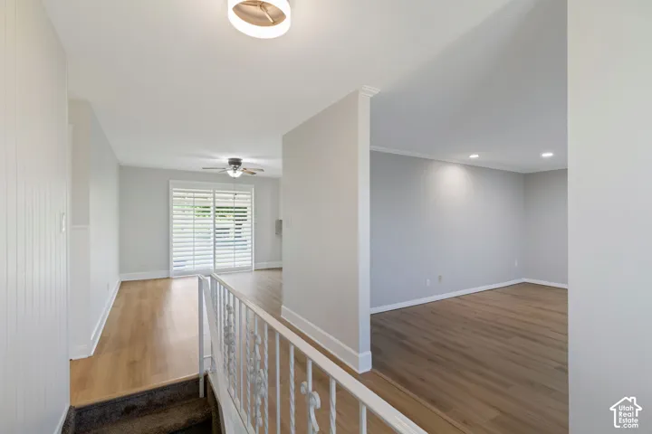 Interior featuring wood-look flooring, white plantation shutters, a ceiling fan, recessed lighting, and a contemporary ceiling fixture