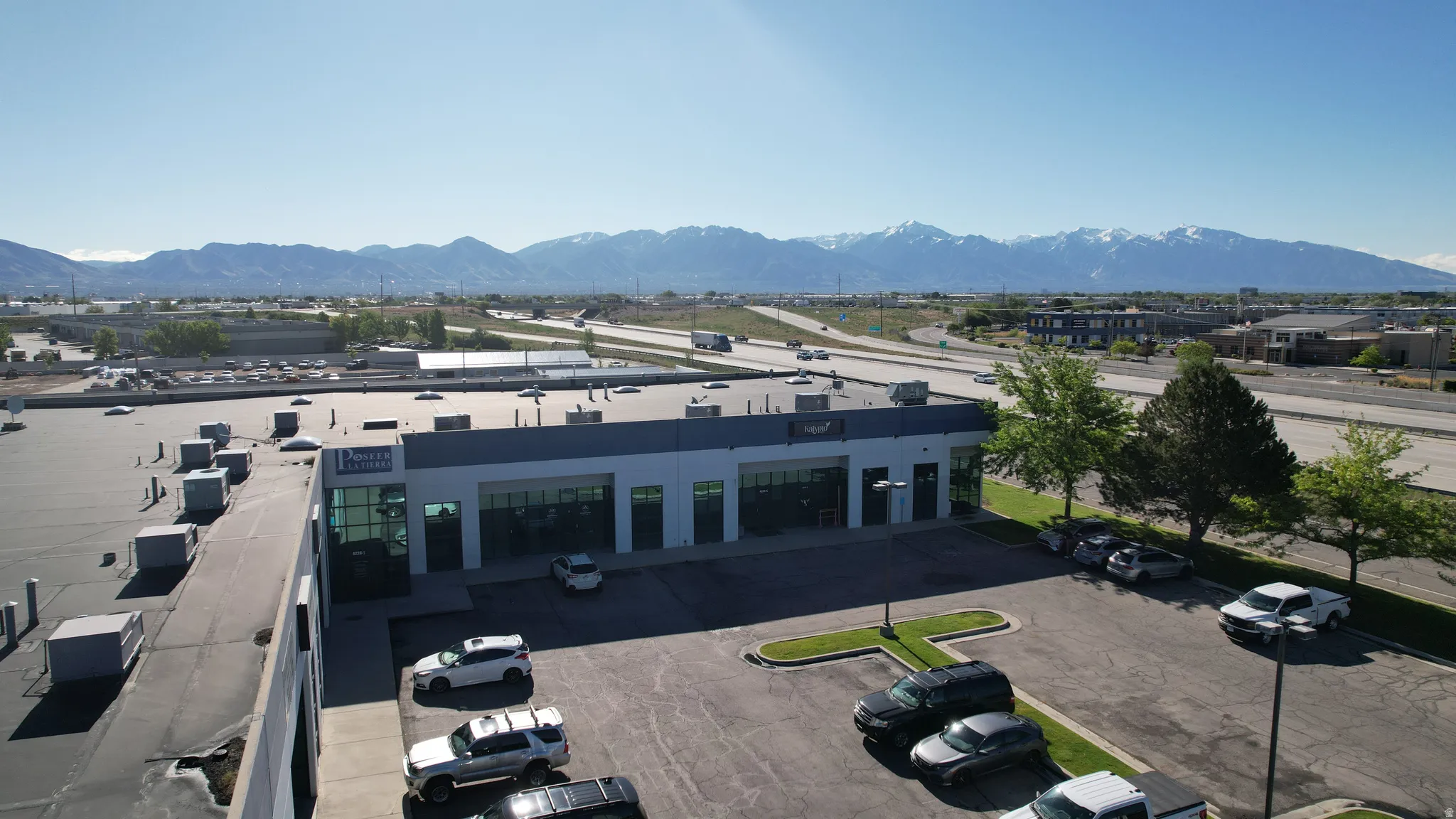 Commercial building featuring a dark gray facade and multiple large glass storefronts