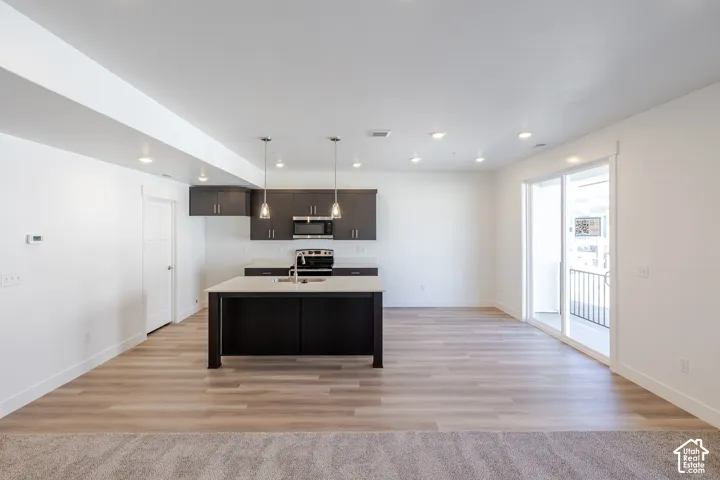 Open-concept living space with wood-finish flooring