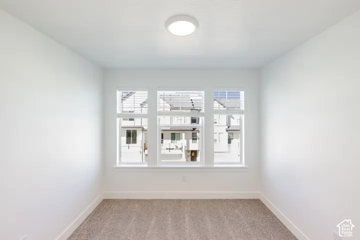 White interior walls with a flush-mount ceiling light