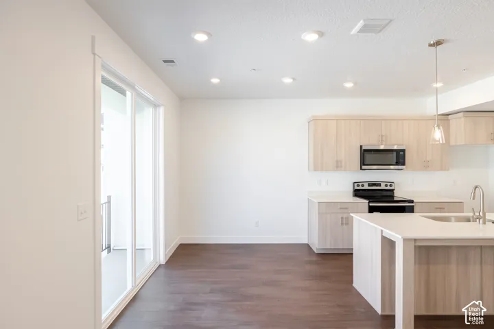 Wood-finish flooring, recessed lighting, and sliding glass doors